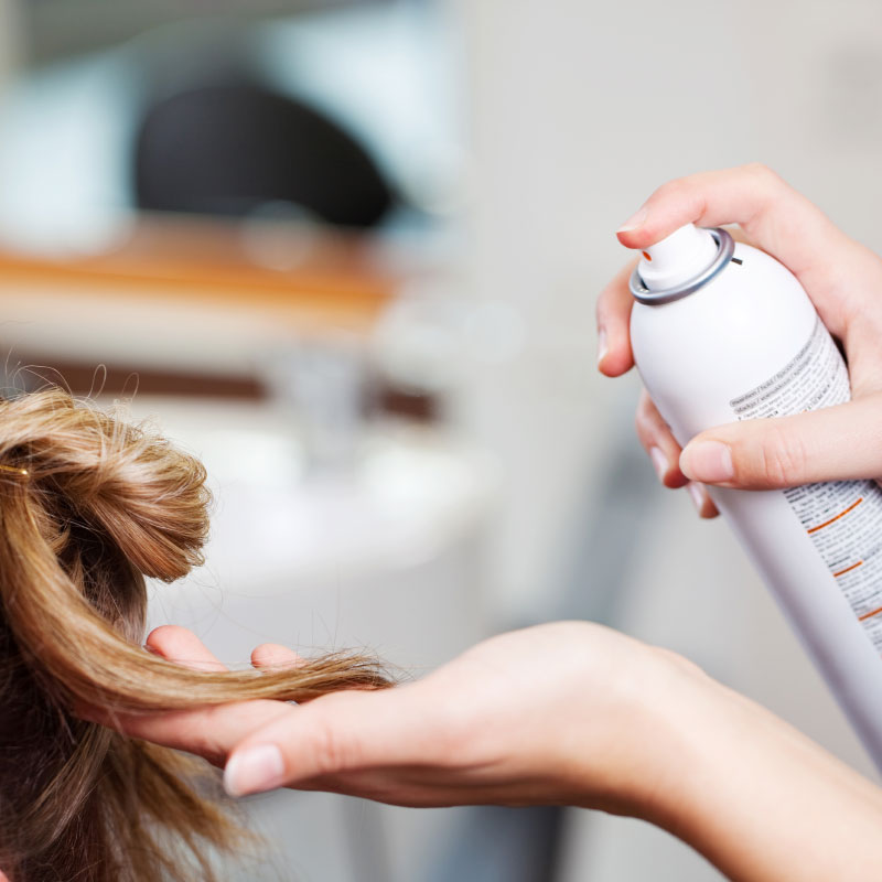 Hairspray being applied to hair at the hairdresser's