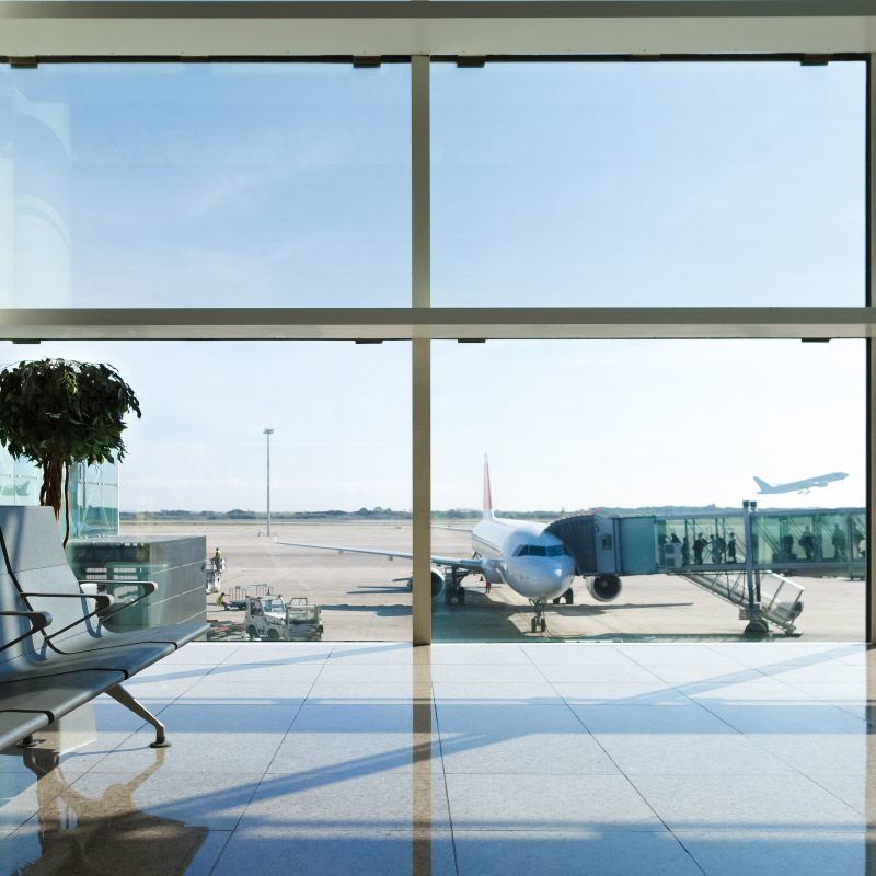 Airport terminal, people go to the plane in the background